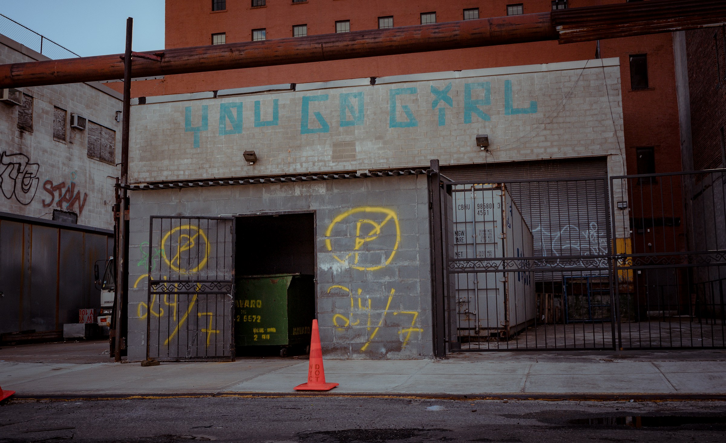 traffic cone beside a brick building, Brooklyn