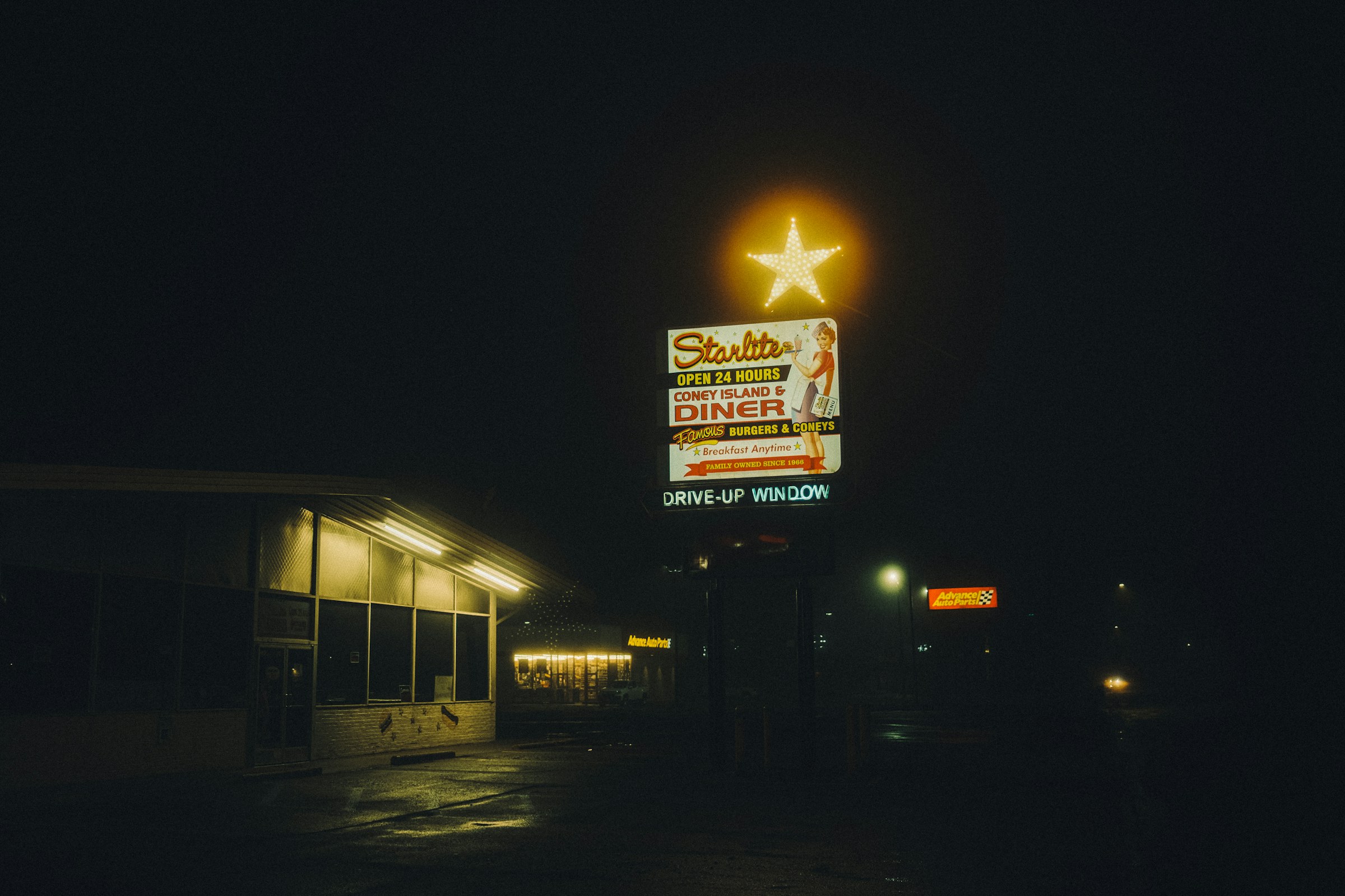 neon diner sign glowing at night, Flint