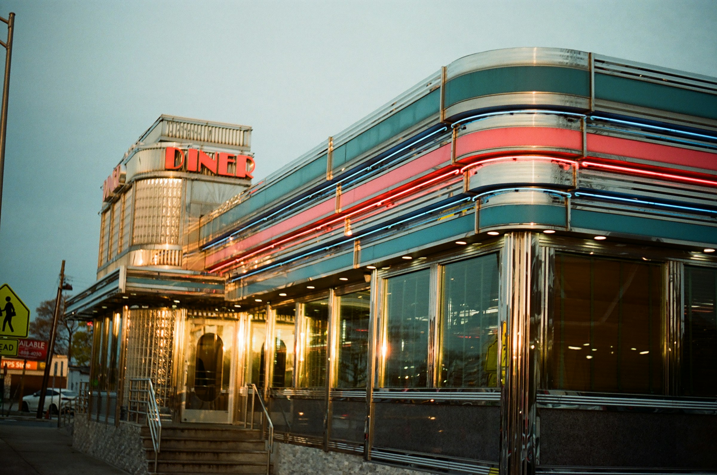 a retro diner with chrome trim and neon at dusk, Long Island