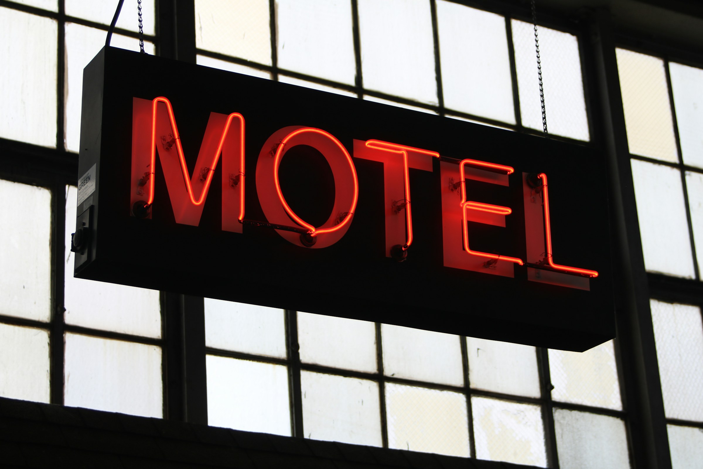 a neon sign hanging from a building, North Carolina